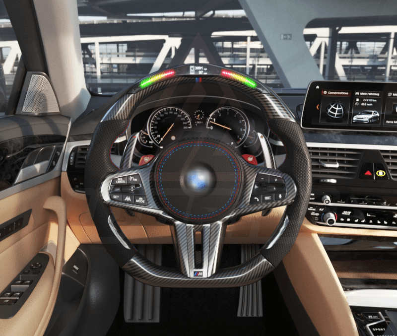 Front view of a BMW G/F chassis, M steering wheel in carbon fiber, black perforated leather, driving assistant pro buttons, m color accents and led shift lights